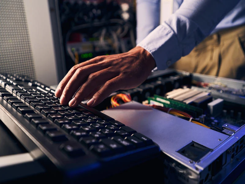 Expert male system administrator upgrading computer components